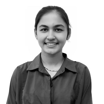 Smiling young woman in a teal button-up shirt against a white background.