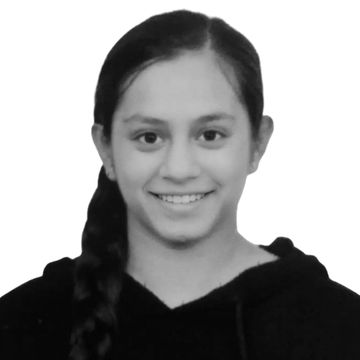 Smiling young woman with braided hair wearing a black hoodie.
