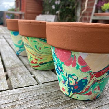 Terracotta plant pots decorated with marbling inks