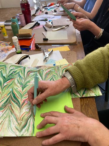 People taking part in a bookbinding class workshop