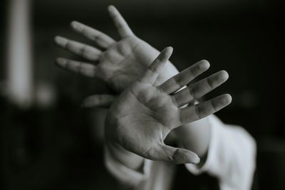 Persons hands shielding them from perceived danger.