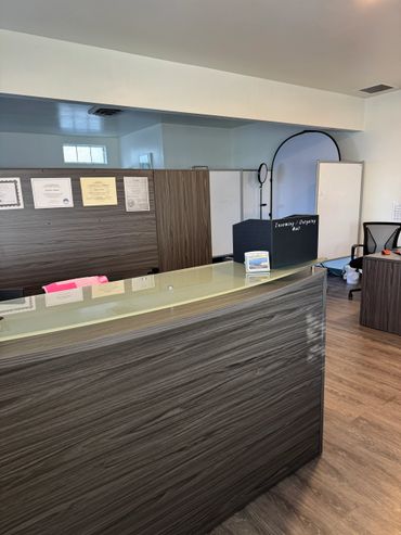 Modern reception desk with certificates on the wall and mail organizer.