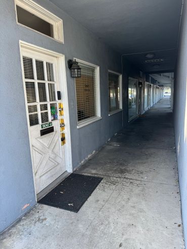 A corridor with blue walls and a white door labeled 9047-H.