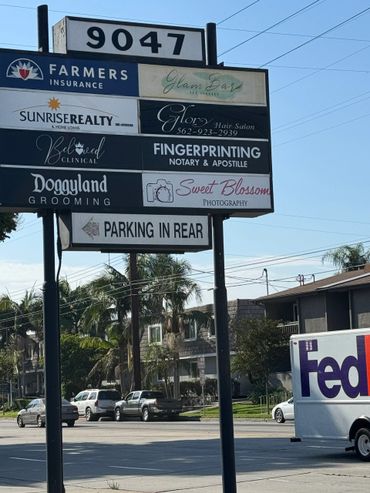 Commercial signboard listing various business services at location 9047.