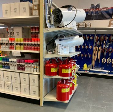 Concrete supplies including paints and sealants along with concrete hand tools on the store shelves.