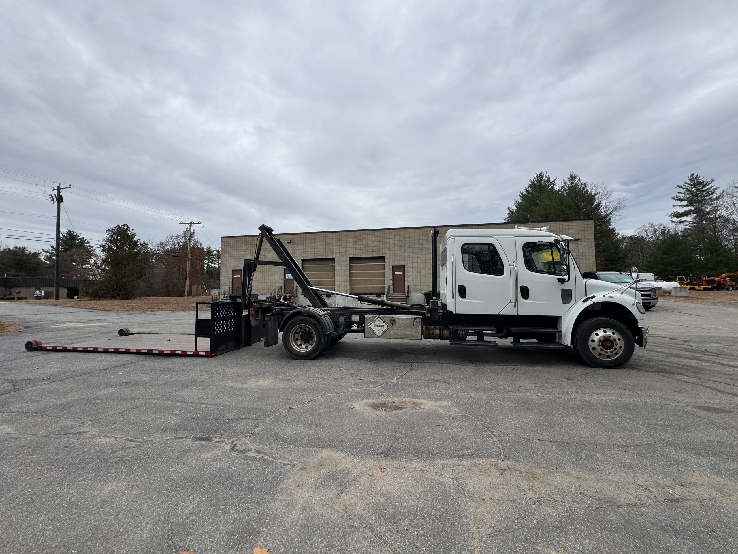 white freightliner with tc160 roll-off body
