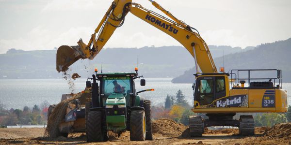 Excavator top loading tractor and scoop