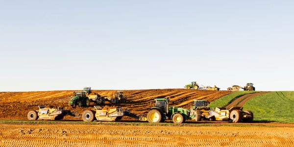 John Deere tractors and scoops on site