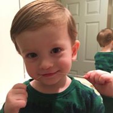 A young boy flossing his teeth
