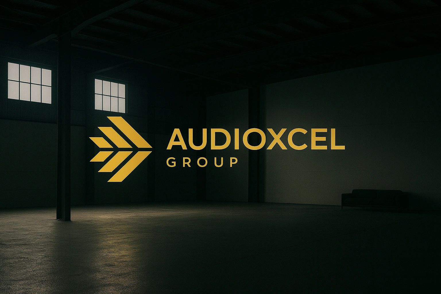 Golden Audioxcel Group logo illuminated in a dark, spacious industrial room.