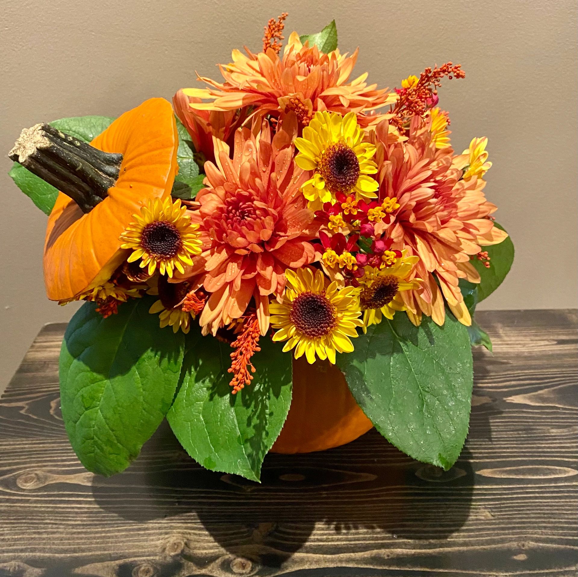 Autumn flower arrangement inside a hollowed pumpkin.