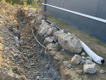 excavated drainage ditch to alleviate water drainage issues