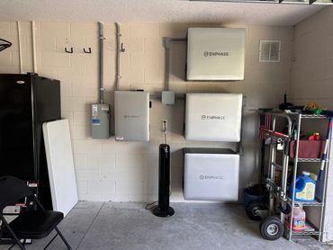 Three wall mounted Enphase Solar Batteries. Service panel electrical panel garage  mounted