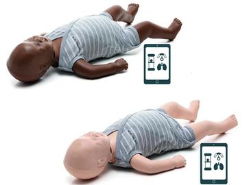 Two baby mannequins with a smartphone app showing medical icons beside them.