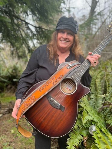 Barbara Anne smiling with her guitar