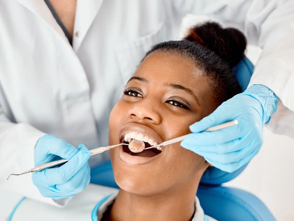 Shot of a young female patient having her teeth examined
