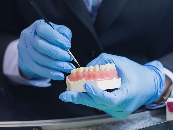 Dentist is working on facial dental prosthetic