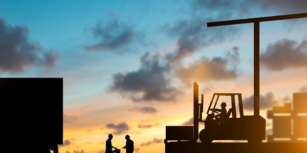 Silhouette inspector are examining the waybill with the Forklift and truck