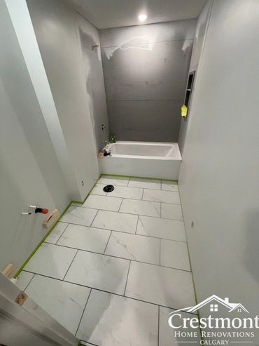 Modern bathroom under renovation with new marble floor tiles.