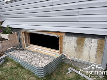 Window removed from house exterior for renovation with siding partially removed.