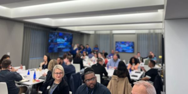 A diverse group in a modern conference room attending a meeting or workshop.