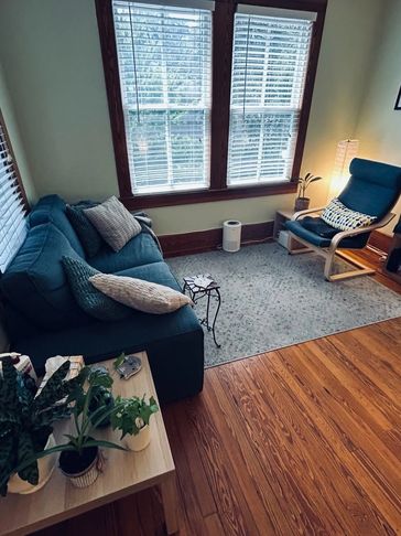 Cozy living room with a blue sofa and lounge chair.