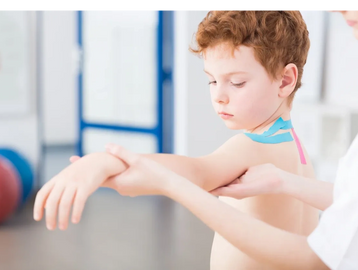 Therapist holding child's arm. We provide award winning Physiotherapy in Oakville and Peel Region.