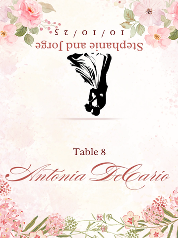 Wedding table card with floral design and bride and groom silhouette.