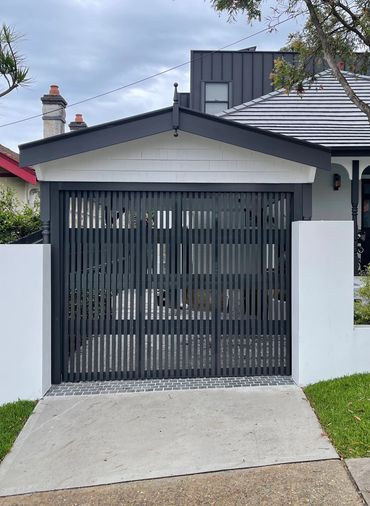 Open vertical baton sectional garage door