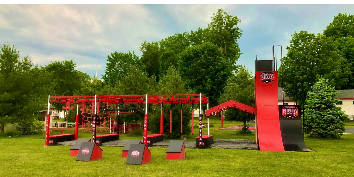 Outdoor ninja warrior obstacle course at summer camp