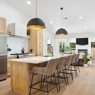 Natural kitchen with black accents and off white countertop.