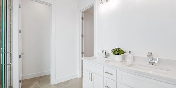 White bathroom with whtie countertops.