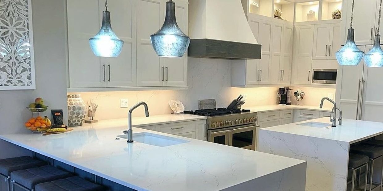 White kitchen with blue pendant lights.