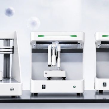 Modern white 3D printers on a clean surface.