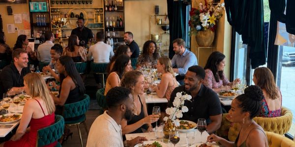People enjoying meals and conversation in a lively restaurant setting.