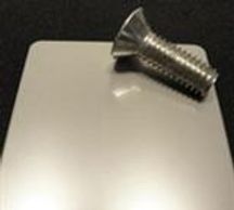 A stainless steel screw on the table