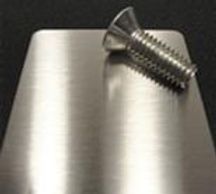 A stainless steel screw on the polished table