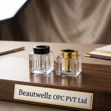 Two elegantcrystal cap for perfume bottles on a wooden base with a nameplate.