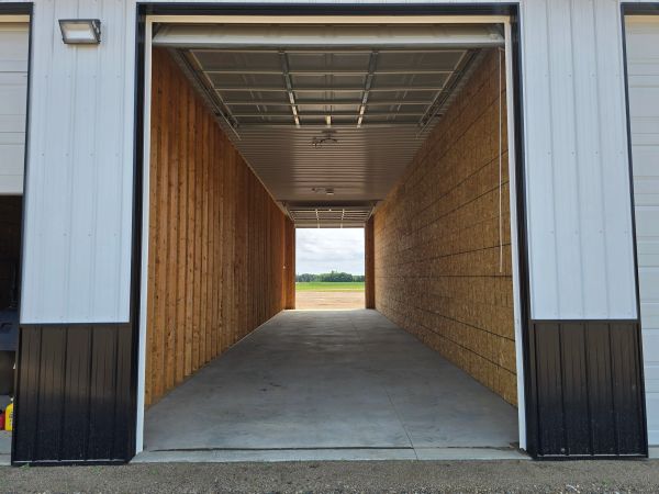 Empty garage with wooden walls and concrete floor.