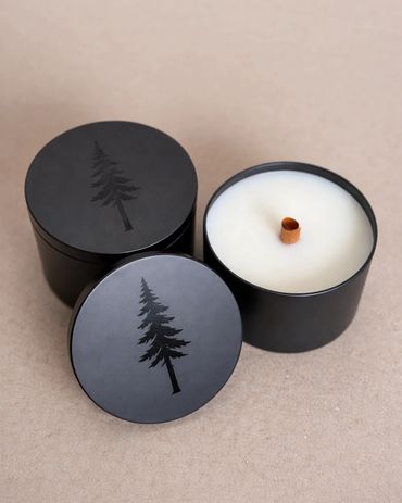 Matte black candle tins with redwood tree design and round wooden wick.