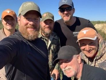 A group of friends smiling and enjoying a beautiful day.