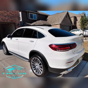 Sleek white Mercedes-Benz GLC 300 coupe parked in a driveway.