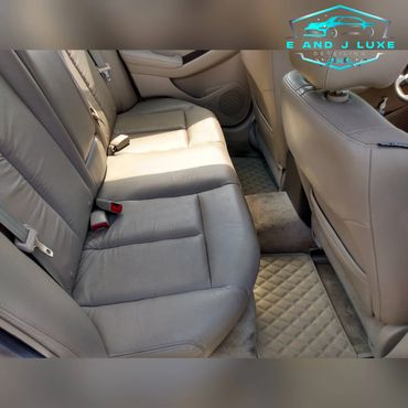 Clean beige leather car seats and floor mats in a well-maintained vehicle interior.