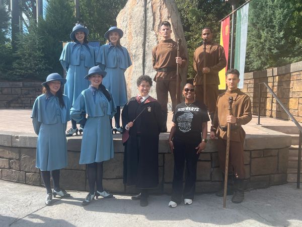 Group in Harry Potter-themed costumes posing outdoors.