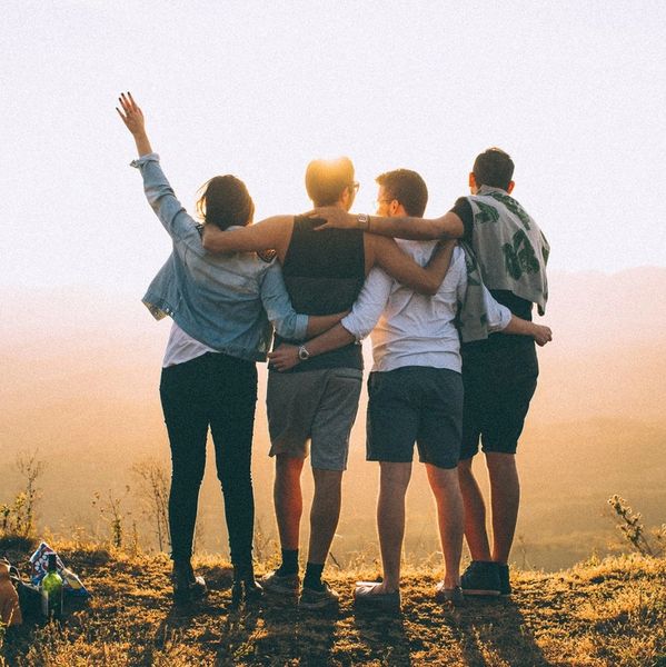Four friends enjoying a sunset together.