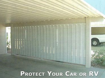 Covered carport with protective privacy screen for vehicles.