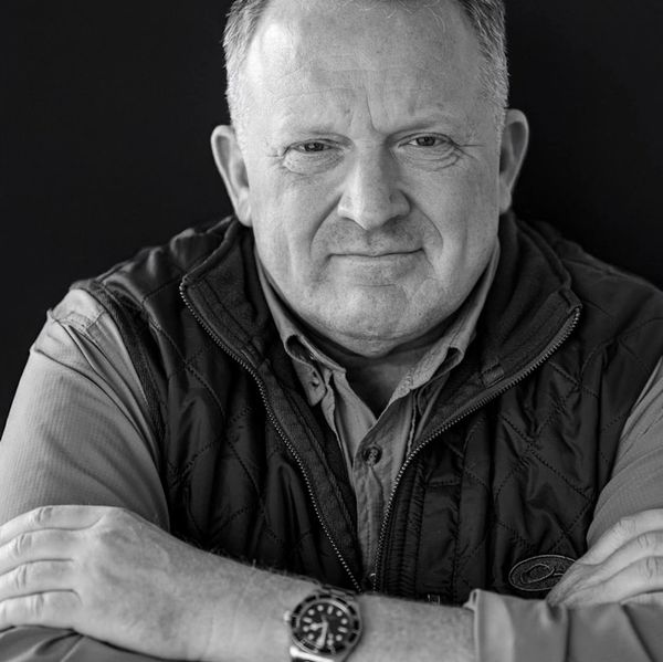 Black-and-white portrait of author Jack MacTavish with his arms crossed