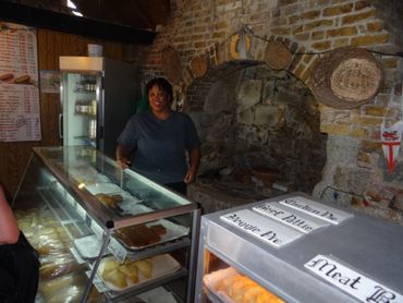 Innenraum der historischen Bäckerei in Nelson's Dockyard Antigua. Backwaren und junge Bäckersfrau.