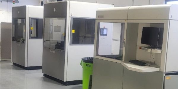 Modern industrial machines in a clean facility.