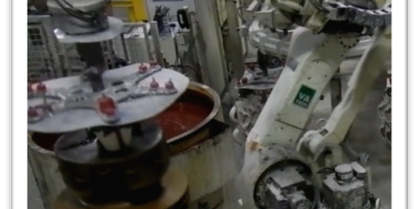 Robotic arm labeled 'SHELLMAKER' working in an industrial setting.
